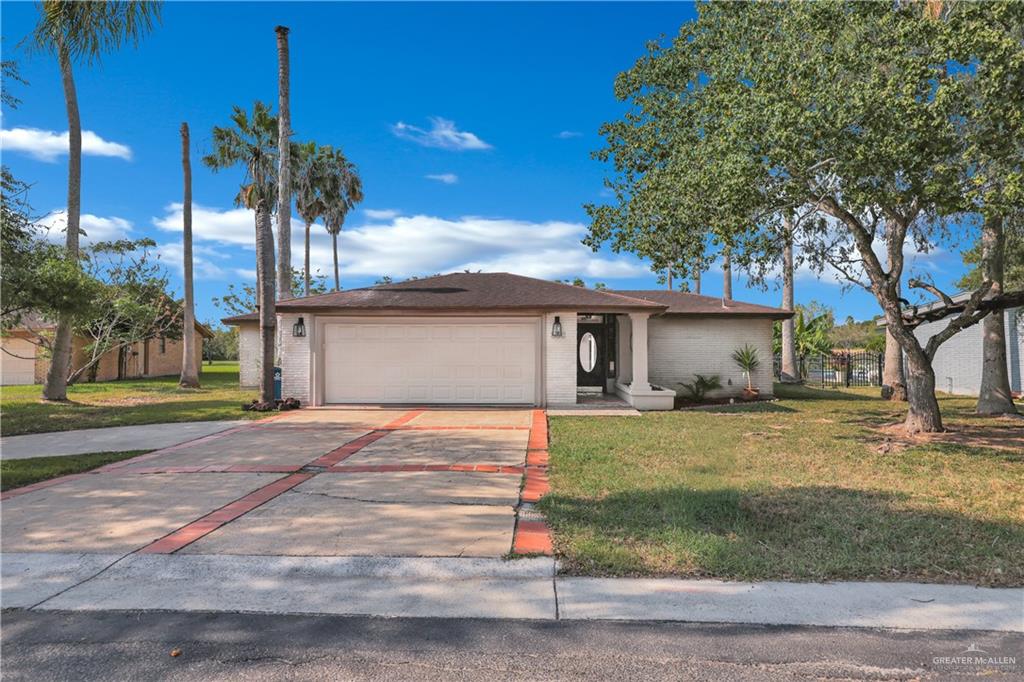 314 Santa Ana Avenue Rancho Viejo, TX 78575 - Photo 2 of 30 a front view of a house with a yard and garage