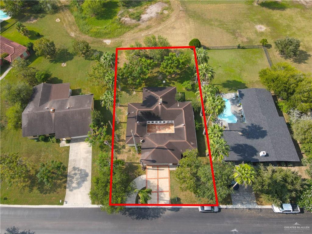 314 Santa Ana Avenue Rancho Viejo, TX 78575 - Photo 24 of 30 an aerial view of a house with a yard and large trees