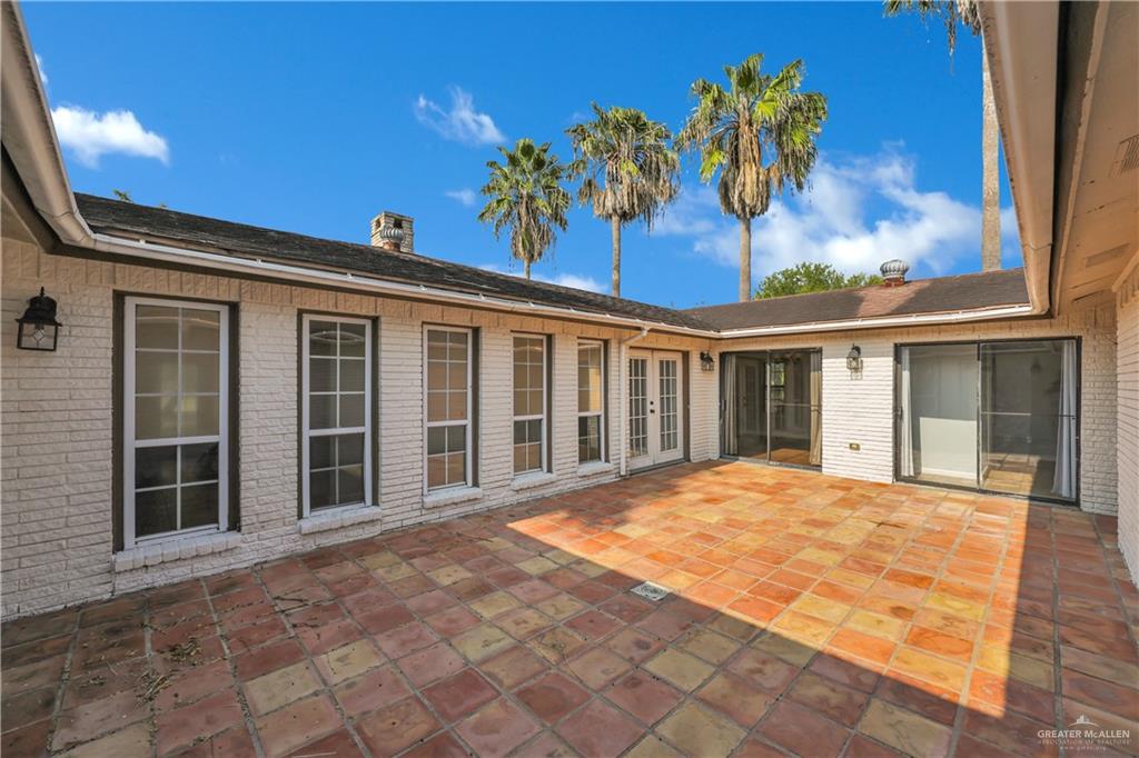 314 Santa Ana Avenue Rancho Viejo, TX 78575 - Photo 3 of 30 a view of a house with a large window and a yard