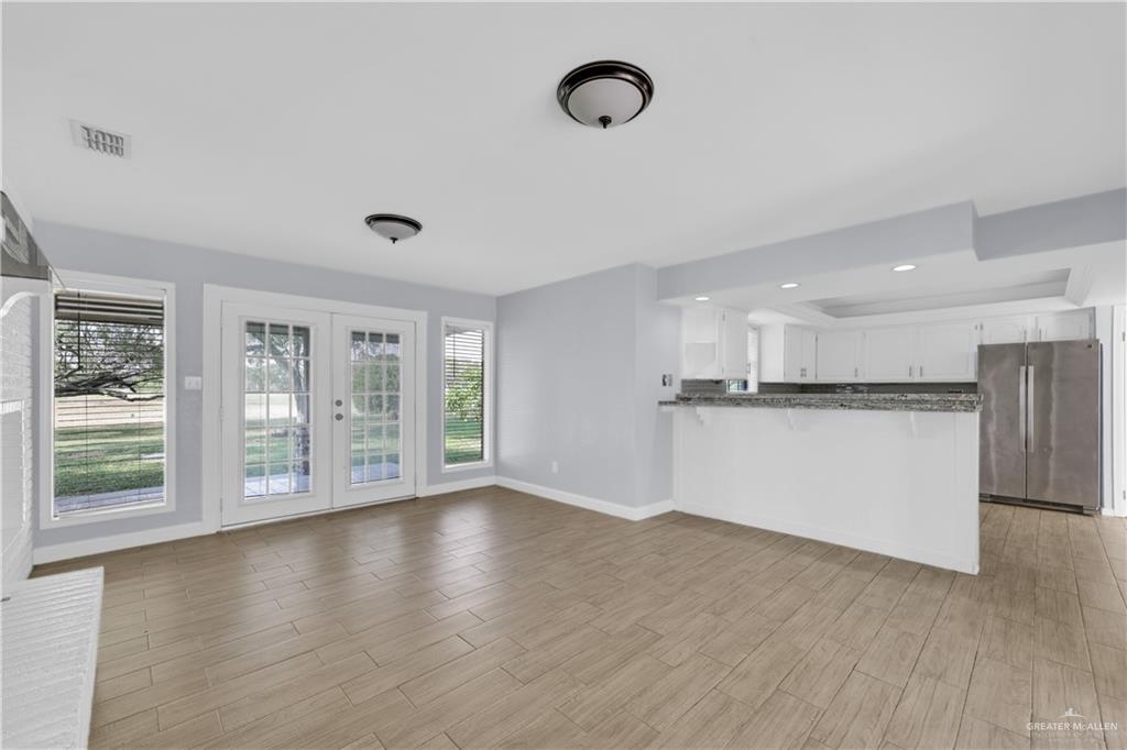 314 Santa Ana Avenue Rancho Viejo, TX 78575 - Photo 4 of 30 a view of an empty room with wooden floor and a window
