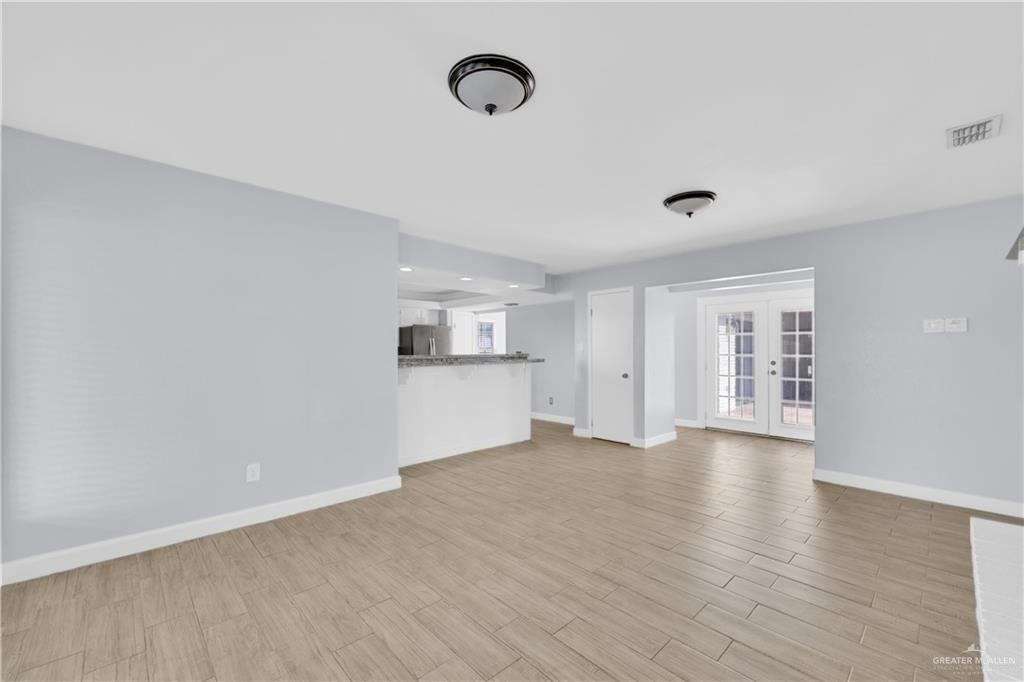 314 Santa Ana Avenue Rancho Viejo, TX 78575 - Photo 5 of 30 a view of an empty room with window and wooden floor
