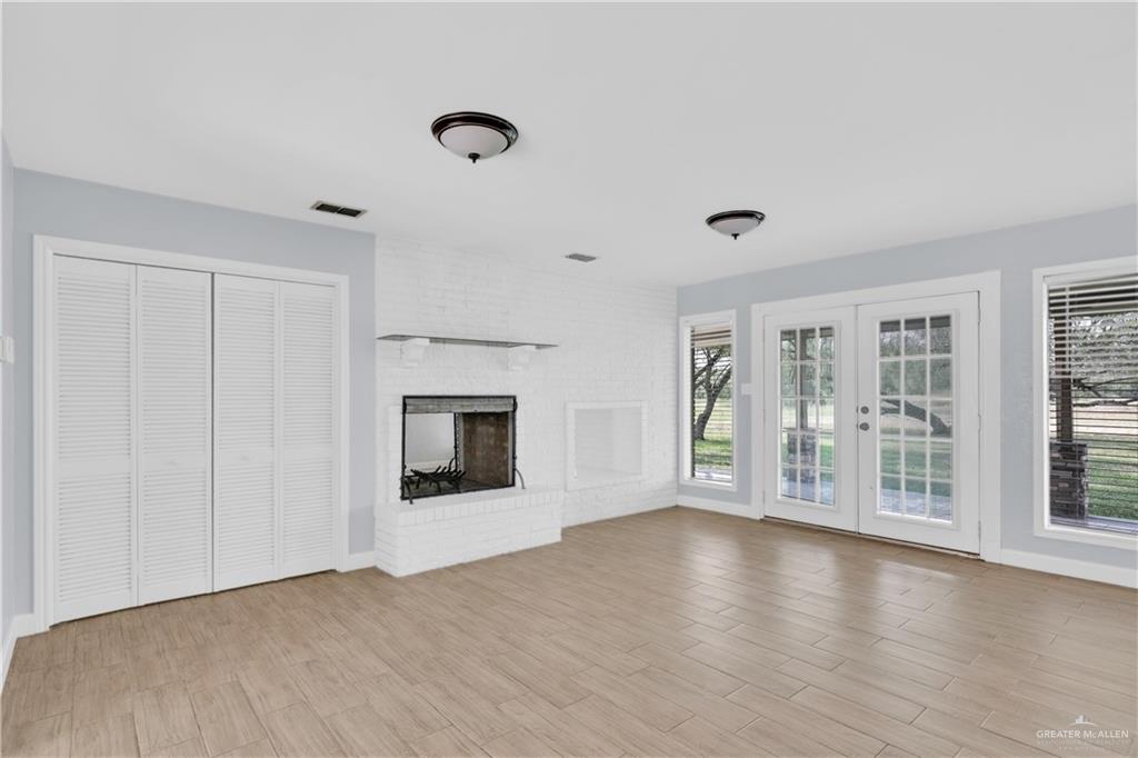 314 Santa Ana Avenue Rancho Viejo, TX 78575 - Photo 6 of 30 a view of an empty room with wooden floor and a window