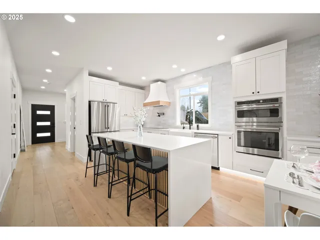 a kitchen with stainless steel appliances kitchen island granite countertop a sink and cabinets