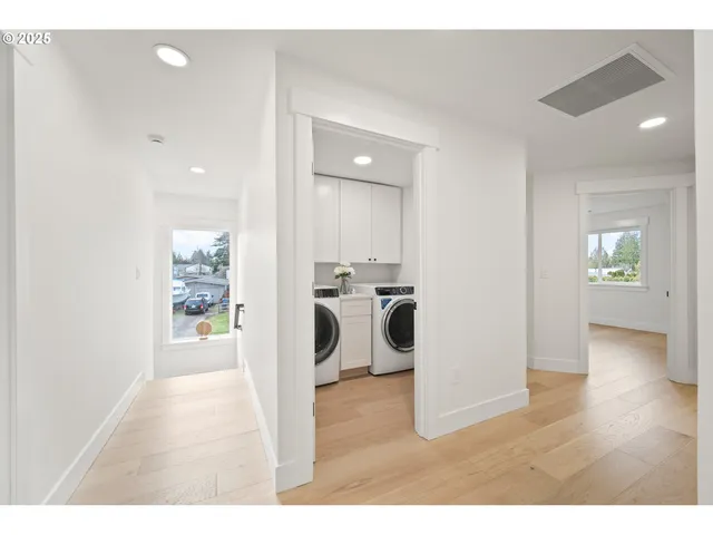 a bathroom with a double vanity sink mirror and bathtub