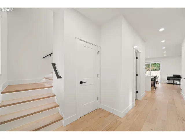 a view of entryway and hall with wooden floor