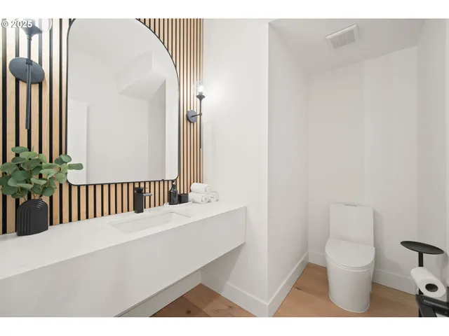 a bathroom with a toilet a sink and a mirror