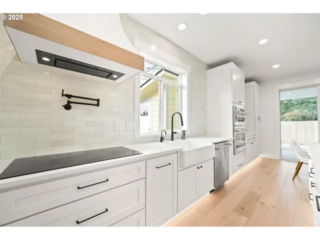 a spacious bathroom with a double vanity sink a mirror and a bathtub