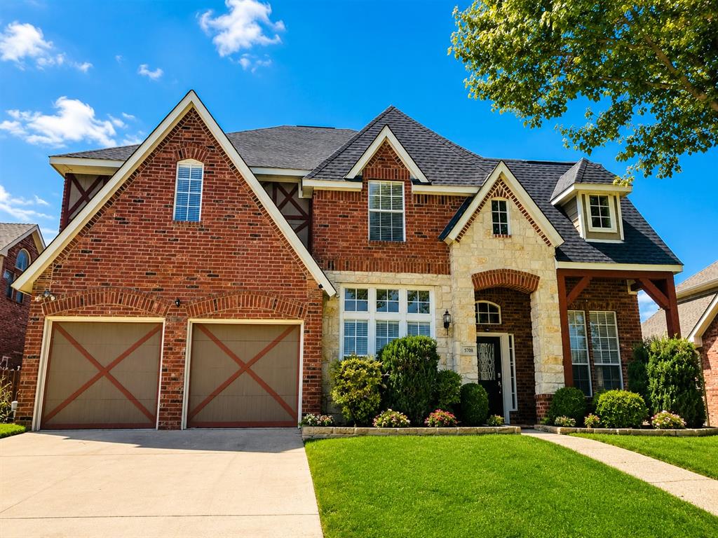 5708 Rickshaw Lane Plano, TX 75094 - Photo 2 of 28 Brick and stone facade featuring gabled rooflines