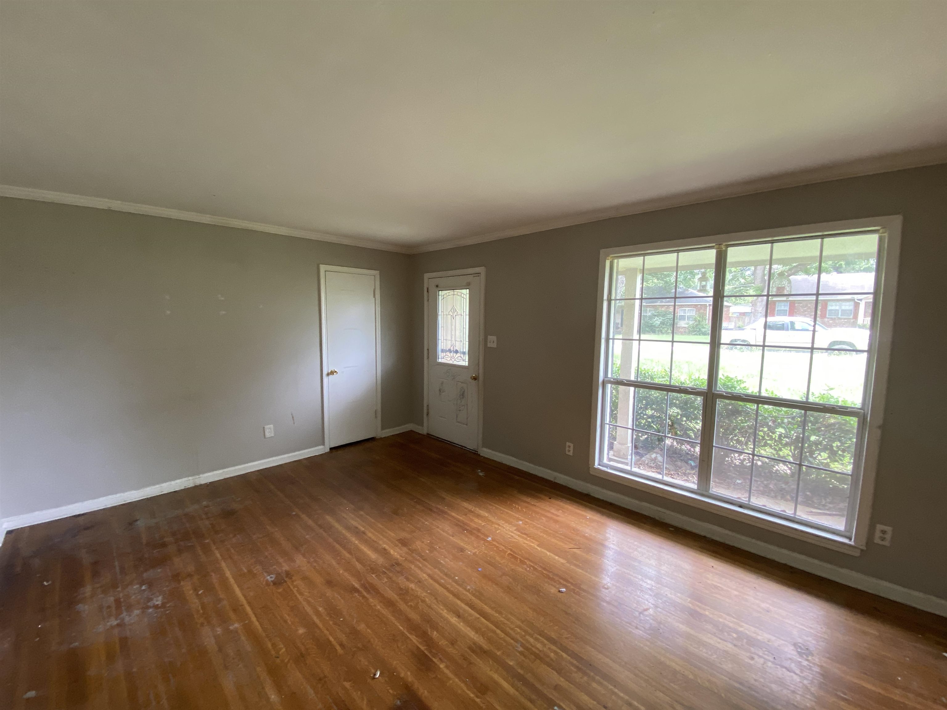 4455 Riche Road Memphis, TN 38128 - Photo 3 of 19 an empty room with wooden floor and windows