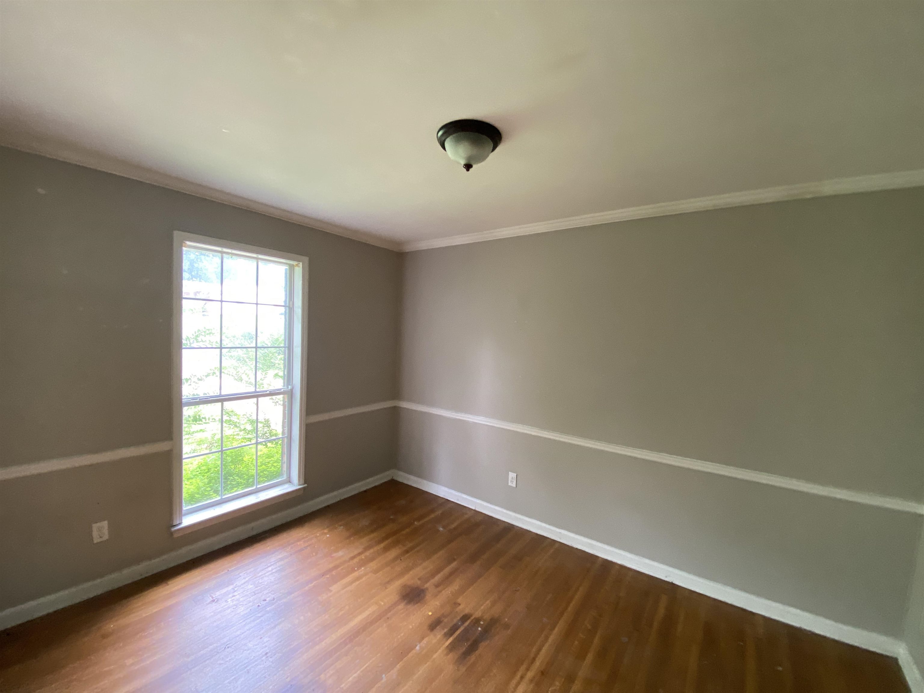 4455 Riche Road Memphis, TN 38128 - Photo 4 of 19 a view of an empty room with wooden floor and a window