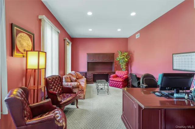 a spacious bedroom with a bed and large windows