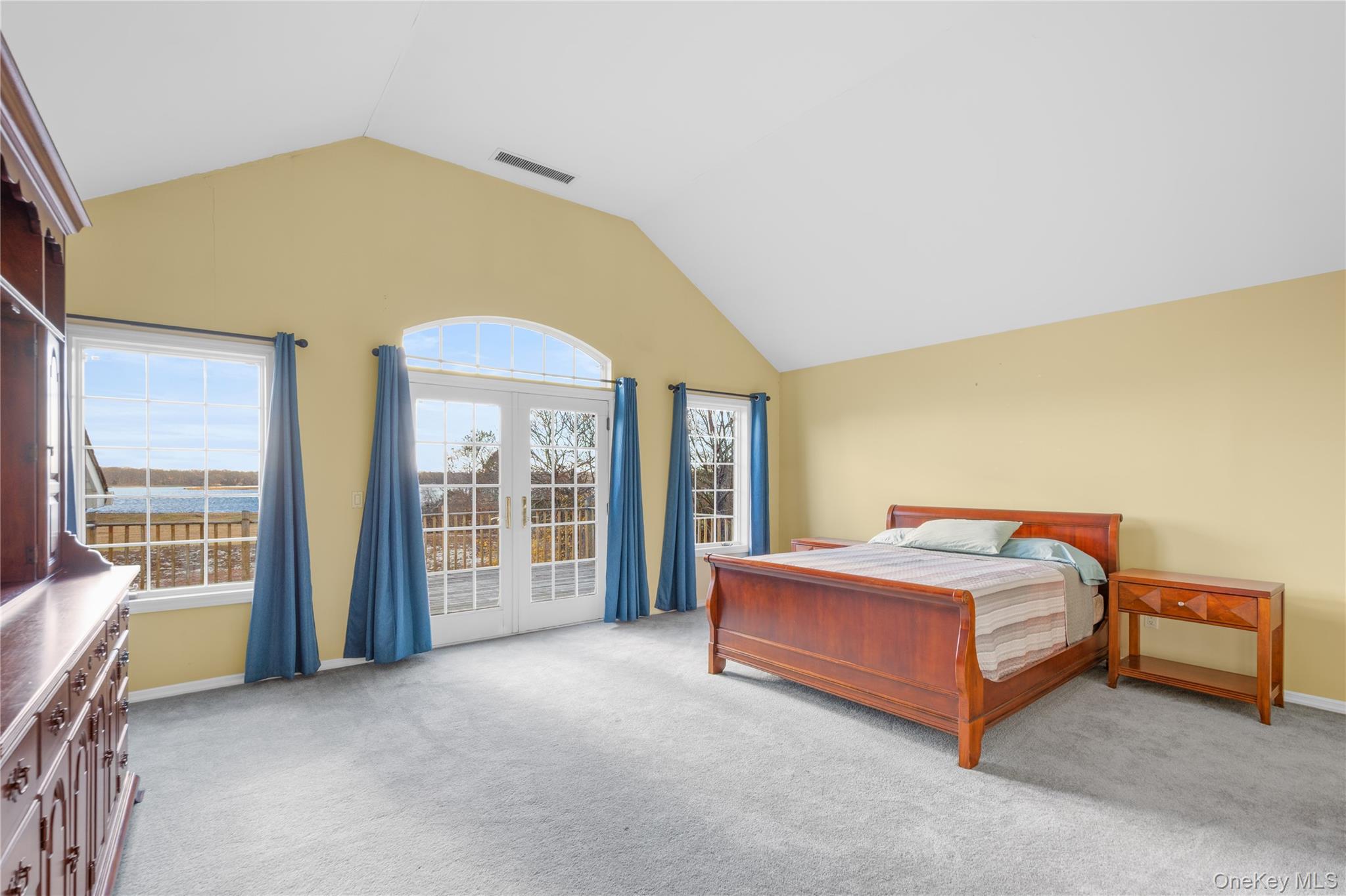 28 Old Neck Road South Center Moriches, NY 11934 - Photo 17 of 43 a spacious bedroom with a bed and large windows
