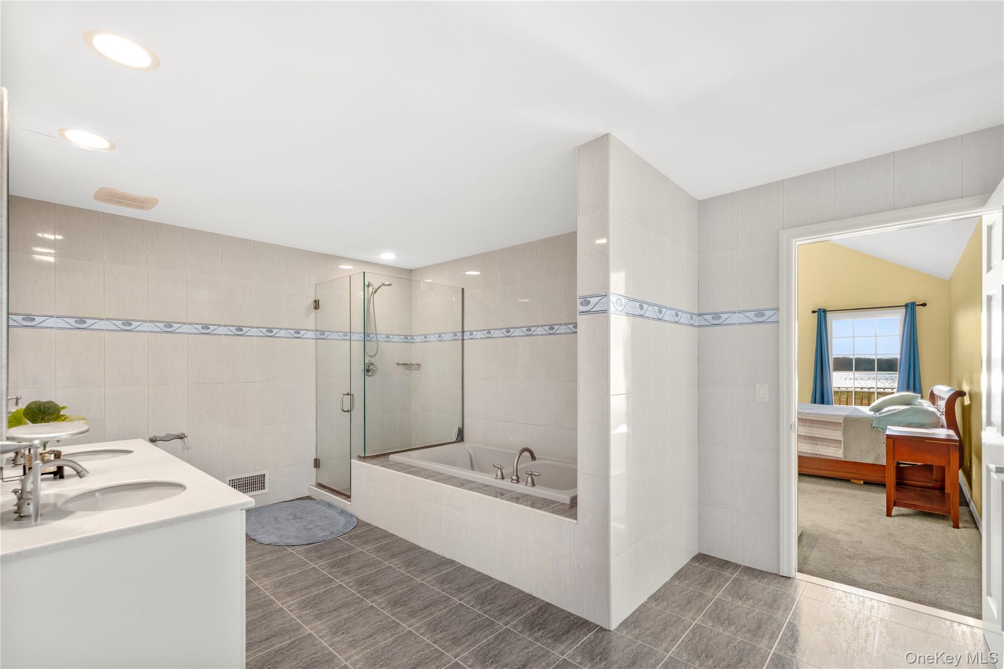 28 Old Neck Road South Center Moriches, NY 11934 - Photo 18 of 43 a bathroom with a bathtub and a sink