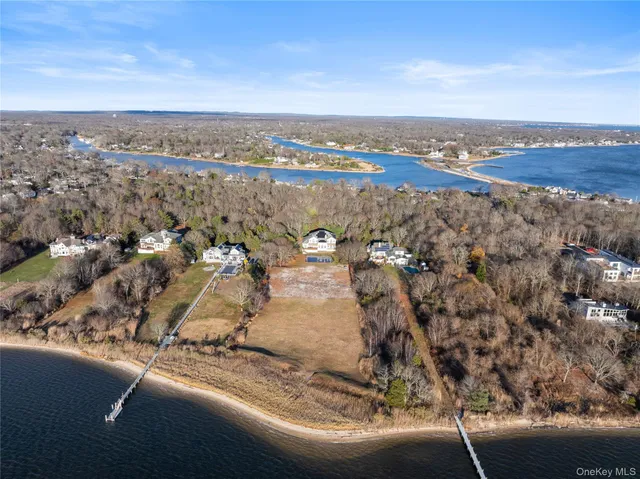 a view of an ocean & house with a yard