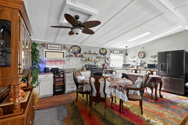 a view of a dining room with furniture and a kitchen