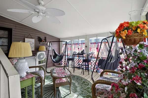 a view of a house with backyard and furniture