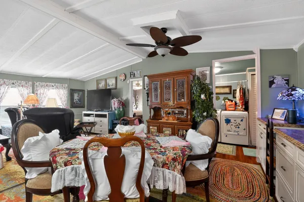 a living room with furniture a ceiling fan and a window
