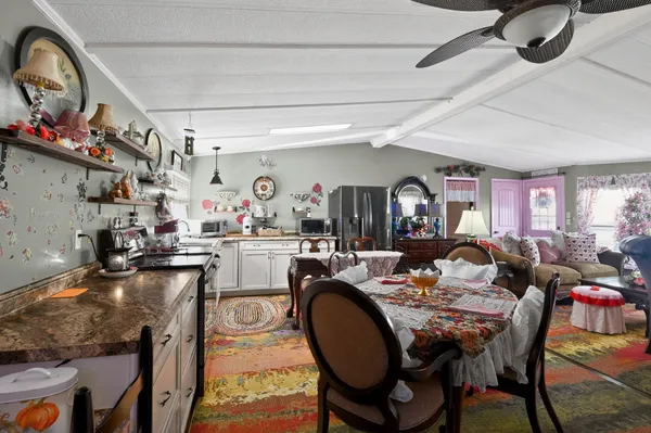 a dining hall with dining table and chairs