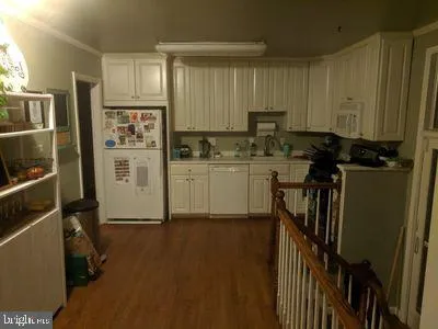 a kitchen with sink refrigerator and cabinets