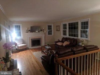 a living room with furniture fireplace and a window