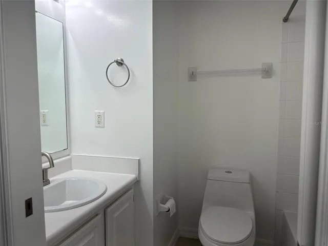 a bathroom with a sink and a white cabinet