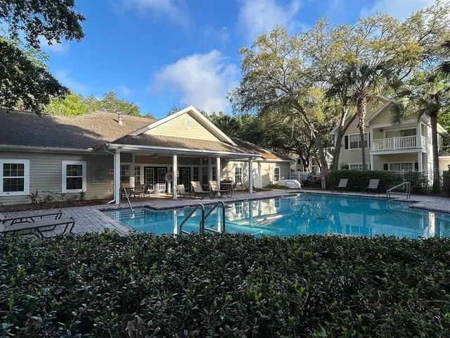 a view of a house with backyard porch and sitting area