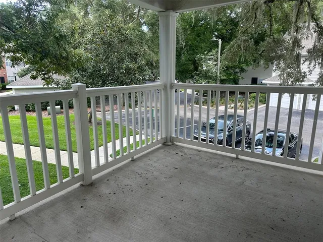a view of a yard with wooden fence