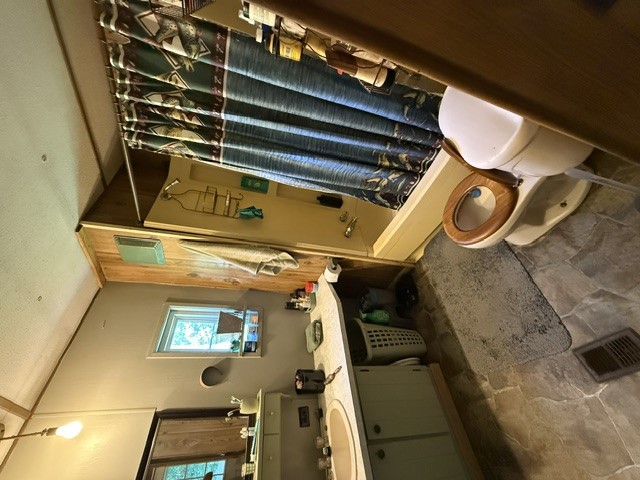 731 Glenn Ferry Road Fair Play, SC 29643 - Photo 9 of 23 Tiled flooring and a wooden toilet seat create a rustic bathroom atmosphere.