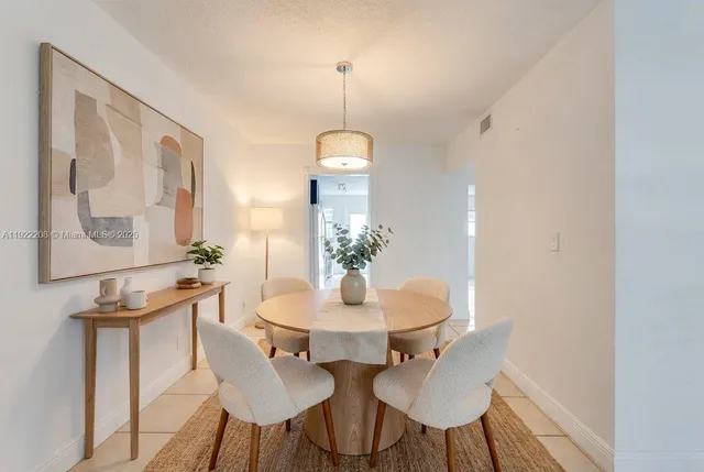 a living room with furniture flowerpot and a potted plant