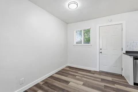 a view of a room with wooden floor and windows