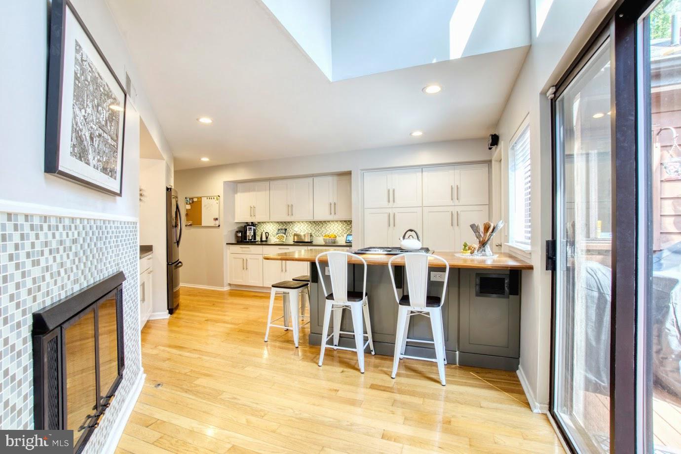 2122 South Bay Lane Reston, VA 20191 - Photo 9 of 41 Double sided fireplace as it faces the kitchen