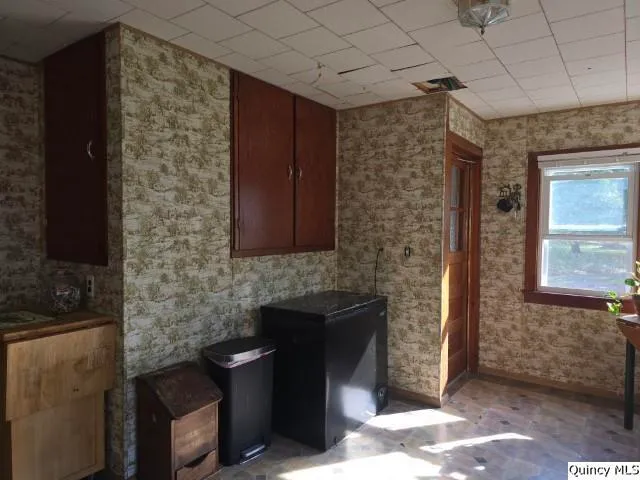 a kitchen with stainless steel appliances granite countertop a refrigerator a stove a sink and a microwave