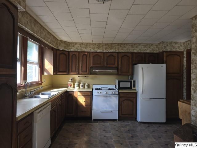102 Center Street Augusta, IL 62311 - Photo 12 of 31 a kitchen with stainless steel appliances granite countertop a refrigerator a stove a sink and a microwave