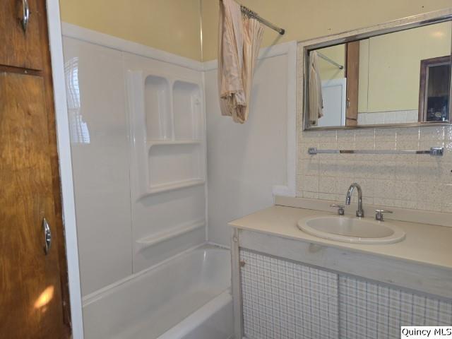 102 Center Street Augusta, IL 62311 - Photo 13 of 31 a bathroom with a sink a mirror and a bathtub