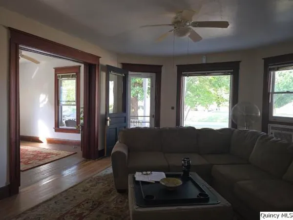 a bedroom with a bed next to a large window