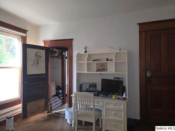 a work room with furniture a flat screen tv and a fireplace