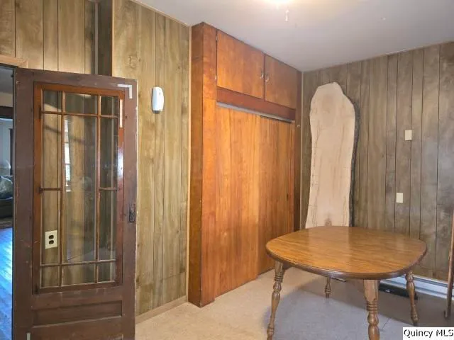 a view of a bedroom with furniture and window
