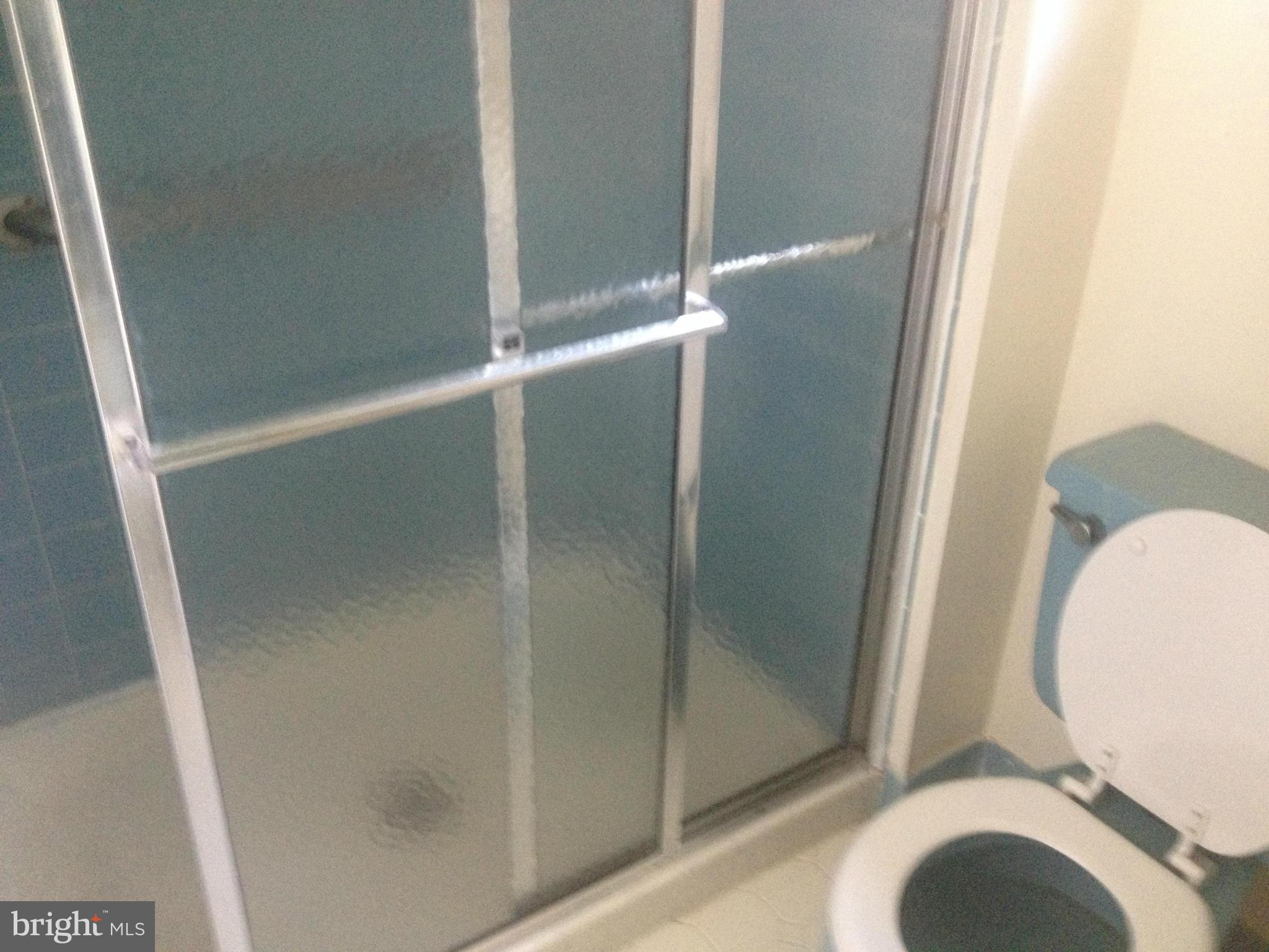 4600 Hawksbury Road Pikesville, MD 21208 - Photo 12 of 17 a bathroom with a glass shower door