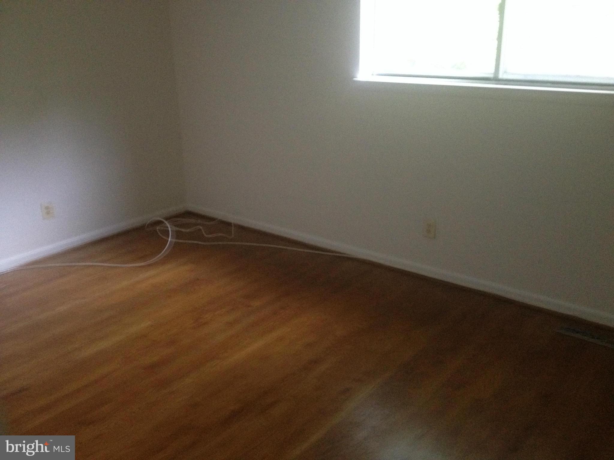 4600 Hawksbury Road Pikesville, MD 21208 - Photo 16 of 17 a view of a small space with wooden floor and a window