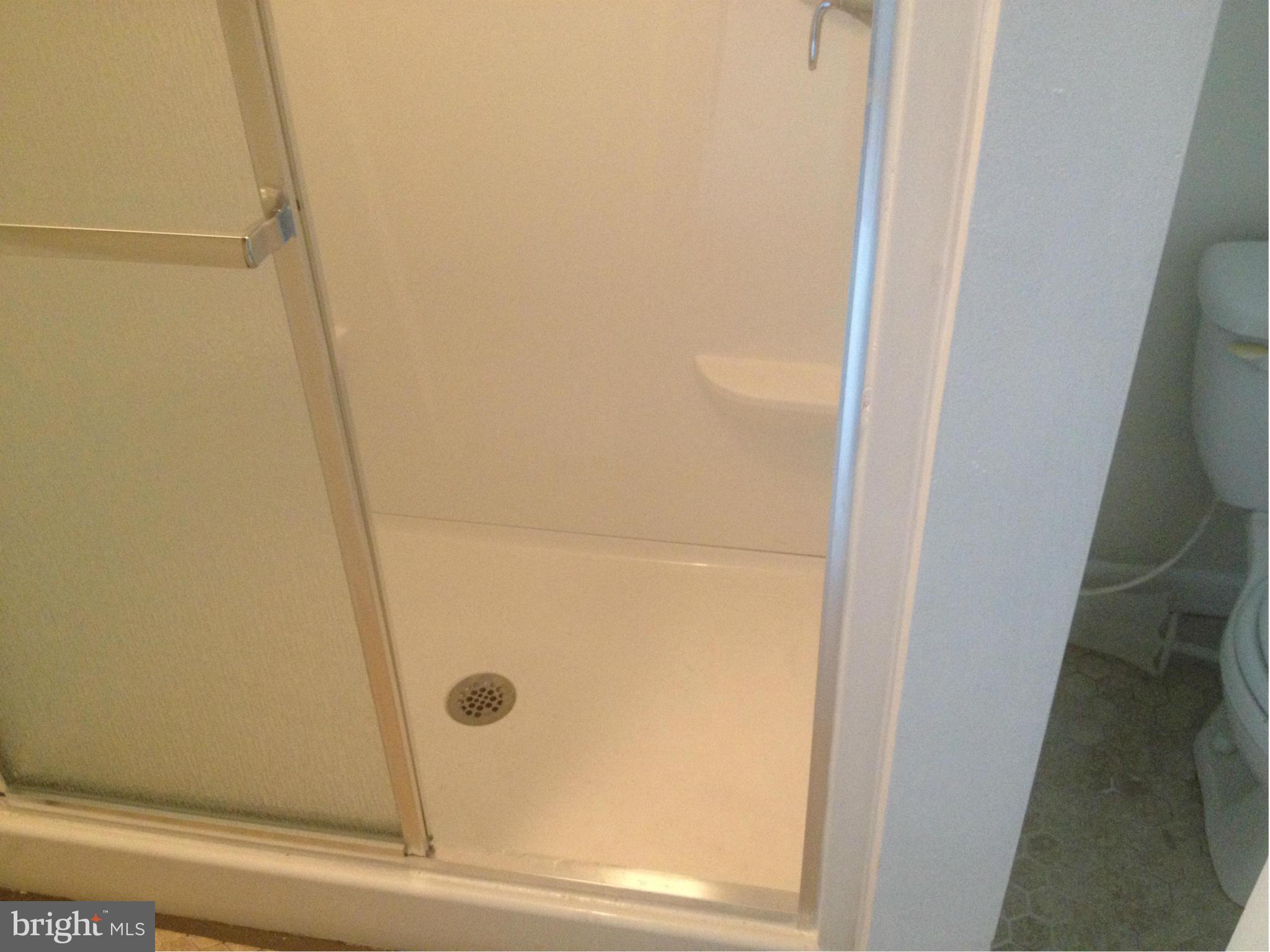 4600 Hawksbury Road Pikesville, MD 21208 - Photo 6 of 17 a bathroom with a glass door