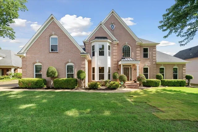 a front view of a house with a yard