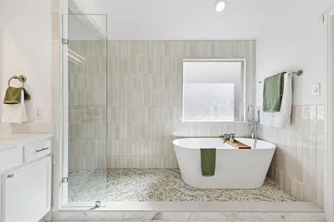 a white bath tub sitting in a bathroom