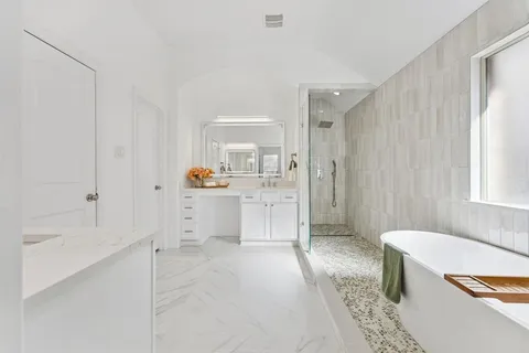a bathroom with a sink a mirror and a bathtub