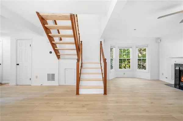 a view of entryway and hall with wooden floor