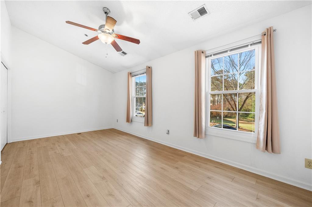 2883 Dresden Square Drive Atlanta, GA 30341 - Photo 14 of 30 an empty room with wooden floor fan and windows