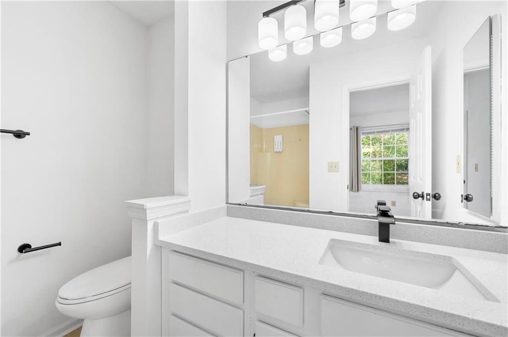2883 Dresden Square Drive Atlanta, GA 30341 - Photo 21 of 30 a bathroom with a sink a toilet and a mirror