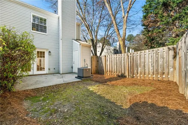 a view of a yard with a large tree