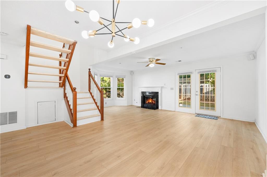 2883 Dresden Square Drive Atlanta, GA 30341 - Photo 6 of 30 a view of an empty room with wooden floor fireplace and a window