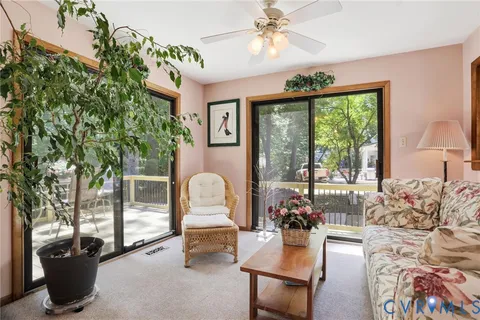 a living room with furniture and large windows