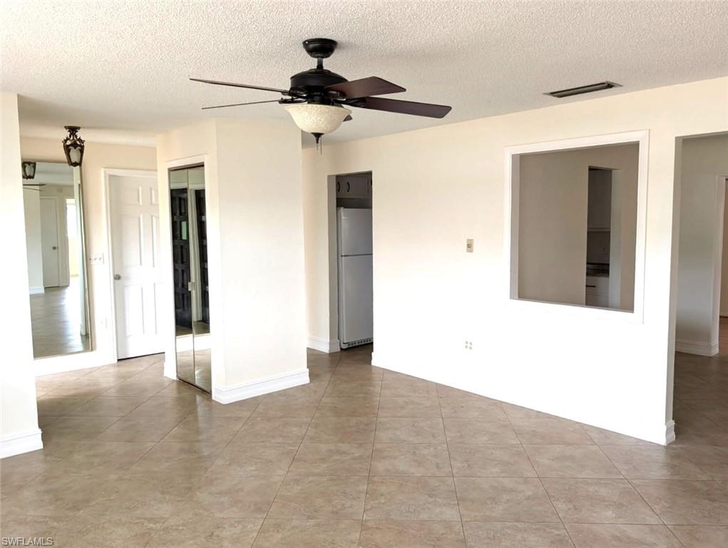 1630 South Fountainhead Road Fort Myers, FL 33919 - Photo 3 of 29 Living room with a with a a view of the main floor plan, ceiling fan, and light tile patterned floors